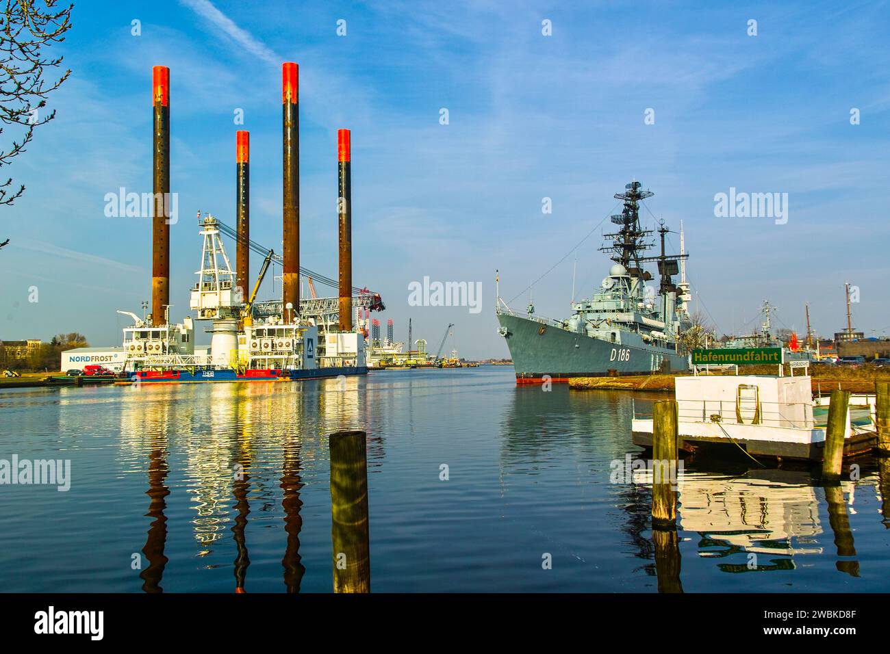 A colorful variety of ports in Wilhelmshaven, from the foundation construction experts of the high seas to the guided missile destroyer of the navy. Stock Photo