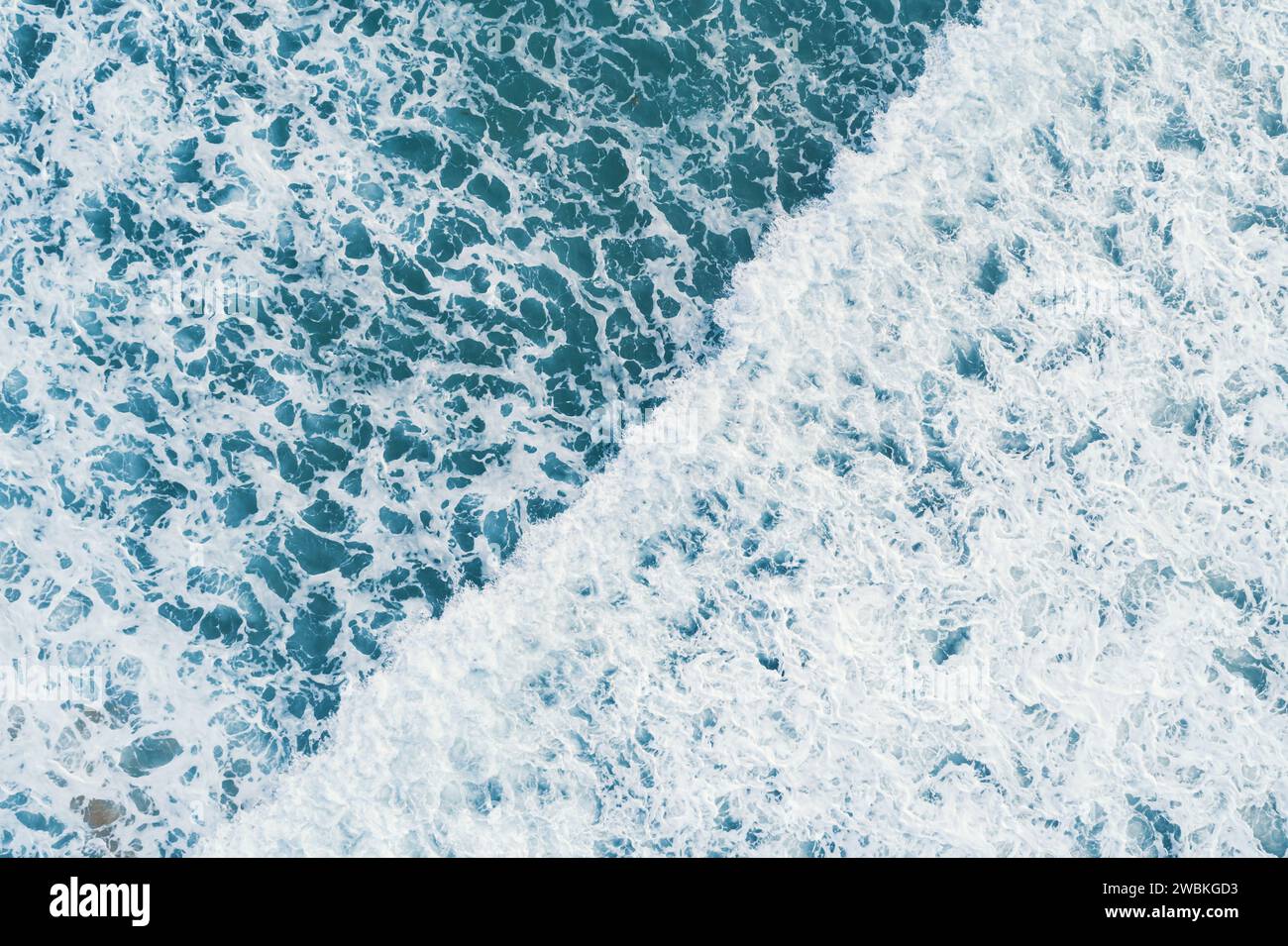 Aerial top view of white foam on the surface of the blue sea Stock ...