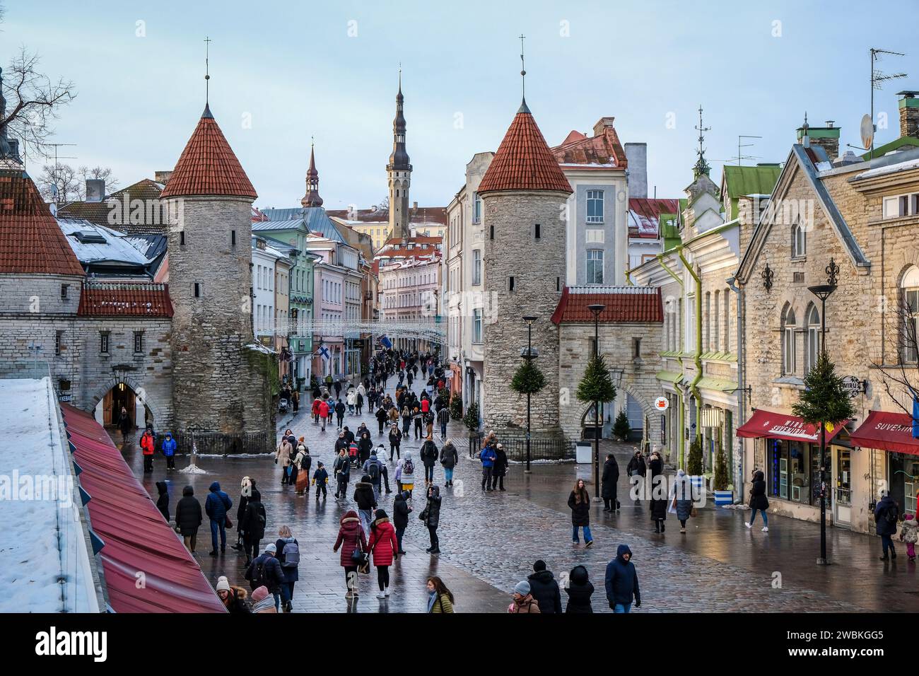 Tallinn, Estonia - Old Town of Tallinn, clay gate, watchtowers of the medieval city gate Viru, the Viru is the main shopping street in the city, behind the tower of the town hall at the town hall square. Stock Photo