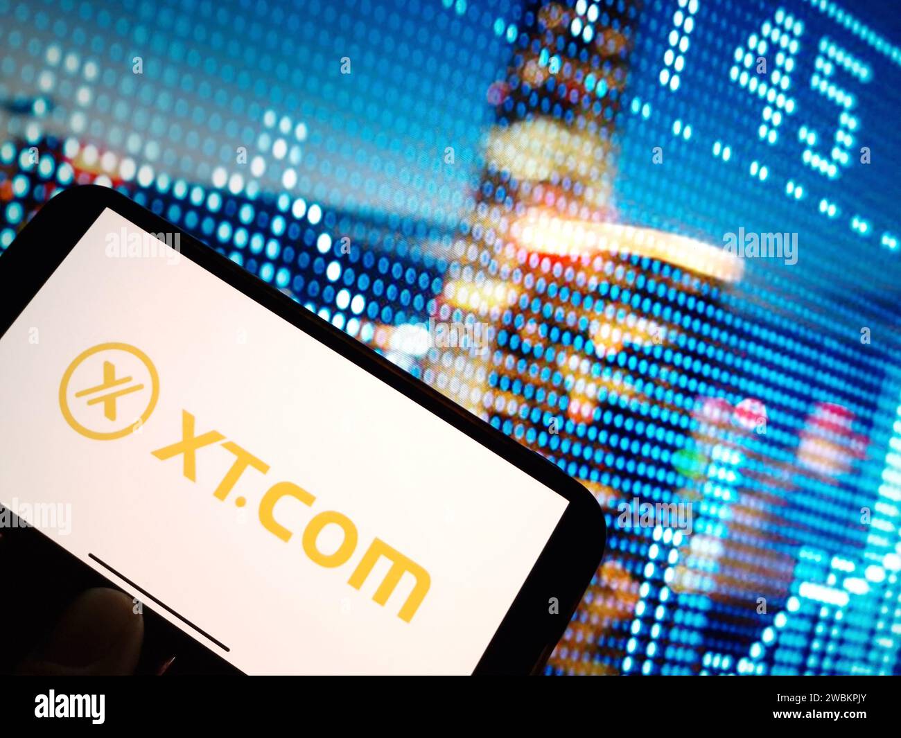 Konskie, Poland - January 05, 2024: XT.COM cryptocurrency exchange logo displayed on smartphone on crypto market data background Stock Photo