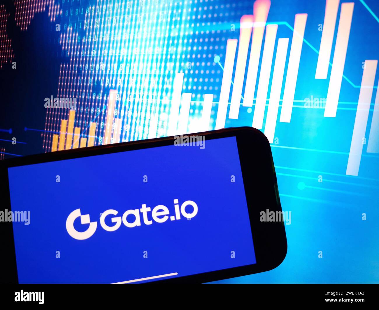 A smartphone with the Gate.io logo on the background of the live trading  webpage. Gate.io dashboard Stock Photo - Alamy