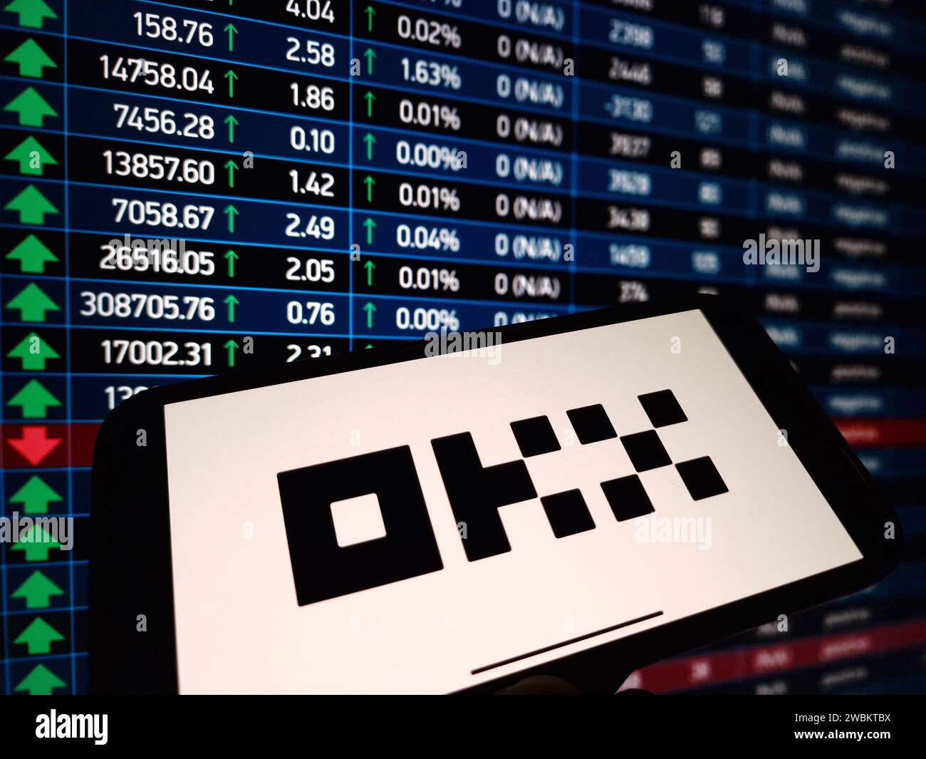 Konskie, Poland - January 05, 2024: OKX cryptocurrency exchange logo displayed on smartphone on crypto market data background Stock Photo