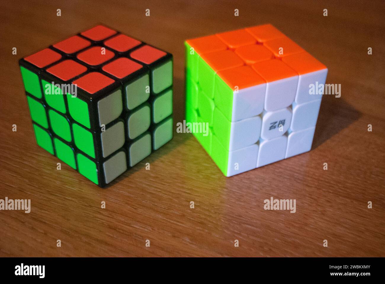 Two rubik's cubes on a desk Stock Photo Alamy