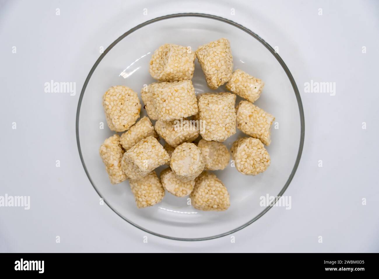 Sesame Ladoo aka til ko ladoo for Makar Maghe Sankranti  dipped in Jaggery for Hindu festival Stock Photo