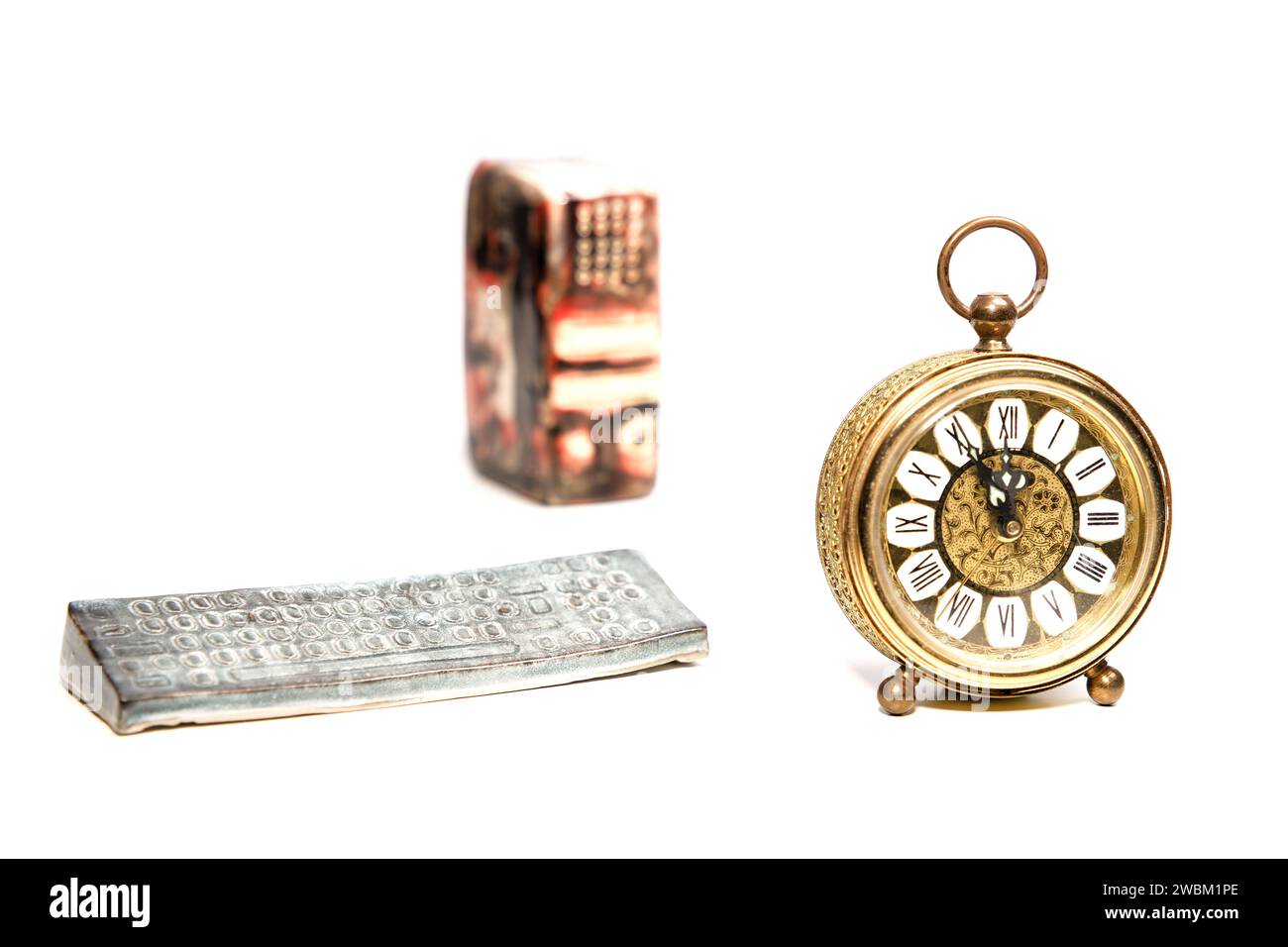 an old golden analog alarm clock with mechanical movement isolated on a