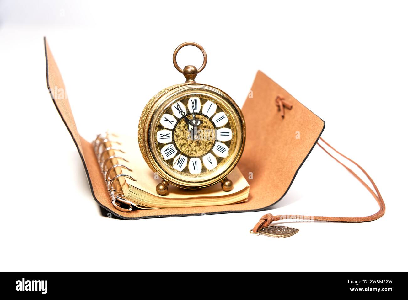 an old golden analog alarm clock with mechanical movement isolated on a ...
