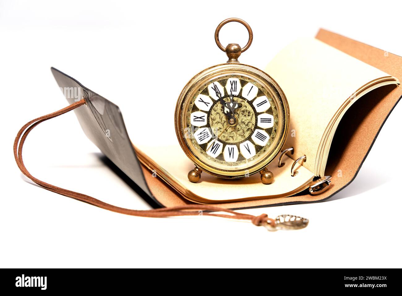 an old golden analog alarm clock with mechanical movement isolated on a ...