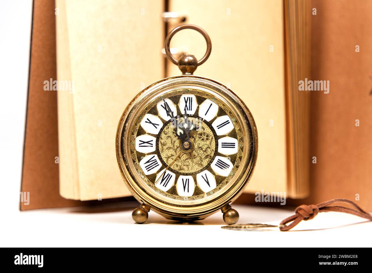an old golden analog alarm clock with mechanical movement isolated on a ...