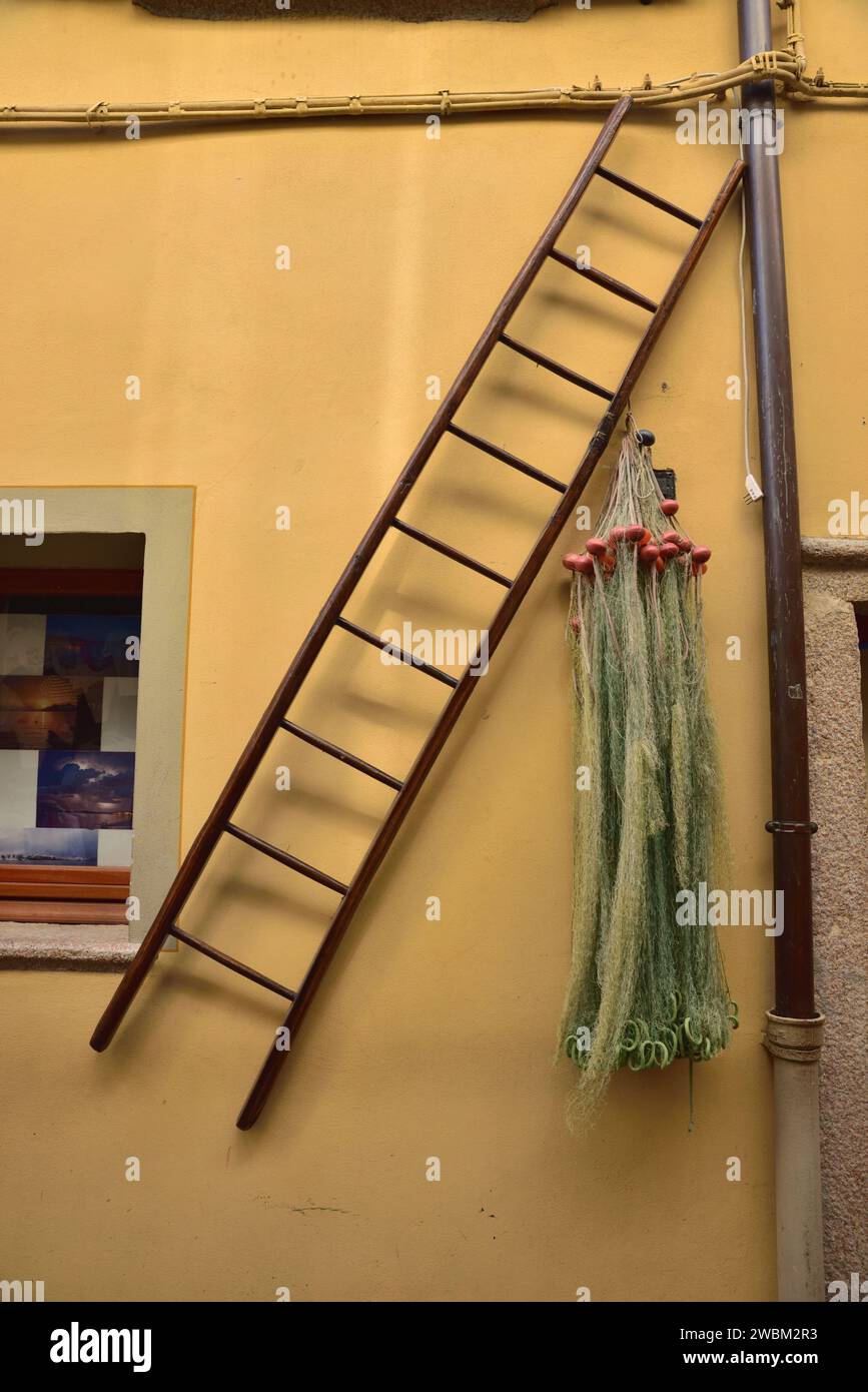 Ladder and fishing nets hanging on the wall of a house on Isola dei Pescatori, on Lake Maggiore, Italy. Stock Photo