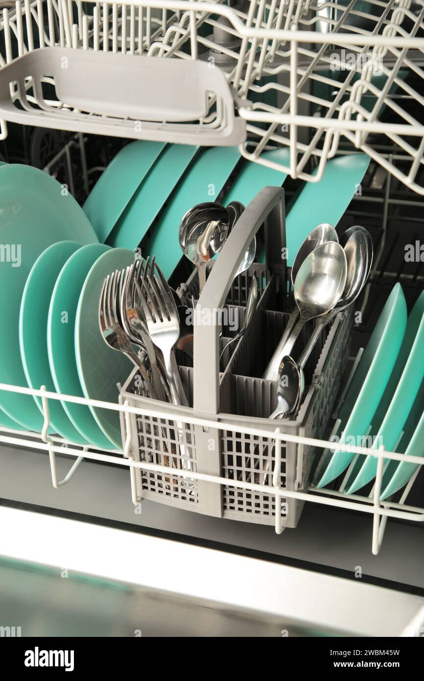 Dishes and cutlery on dishwashing machine. Clean dishes. Top view Stock