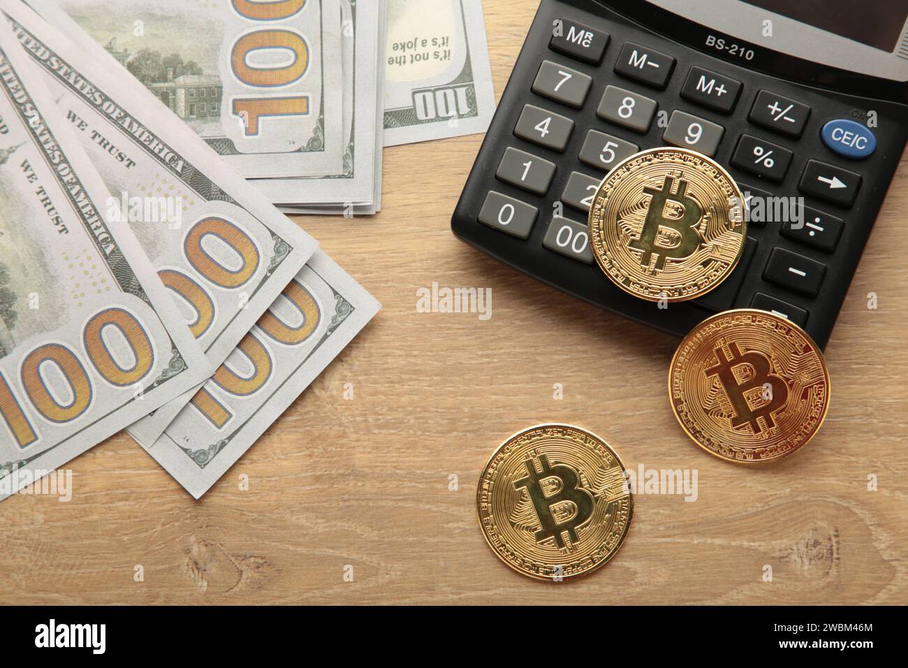 Bitcoin on top of calculator Stock Photo - Alamy