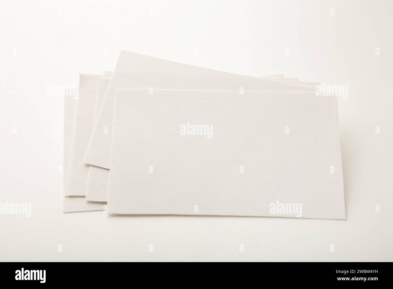 Blank white business cards on white paper background. Mockup for branding identity. Template for graphic designers portfolios. Stock Photo
