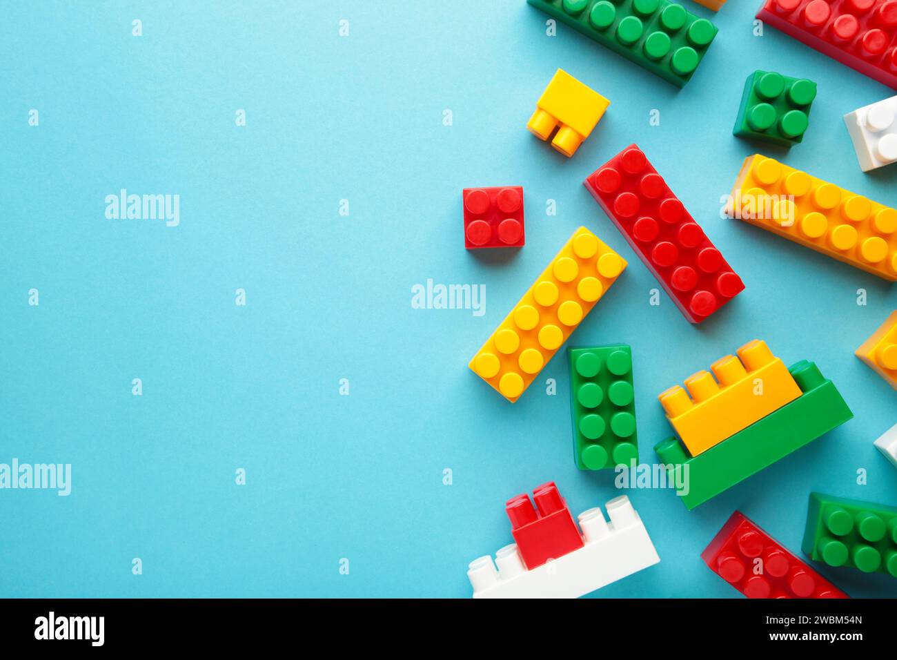 Multicolored blocks of the children's constructor lie on a blue background Stock Photo
