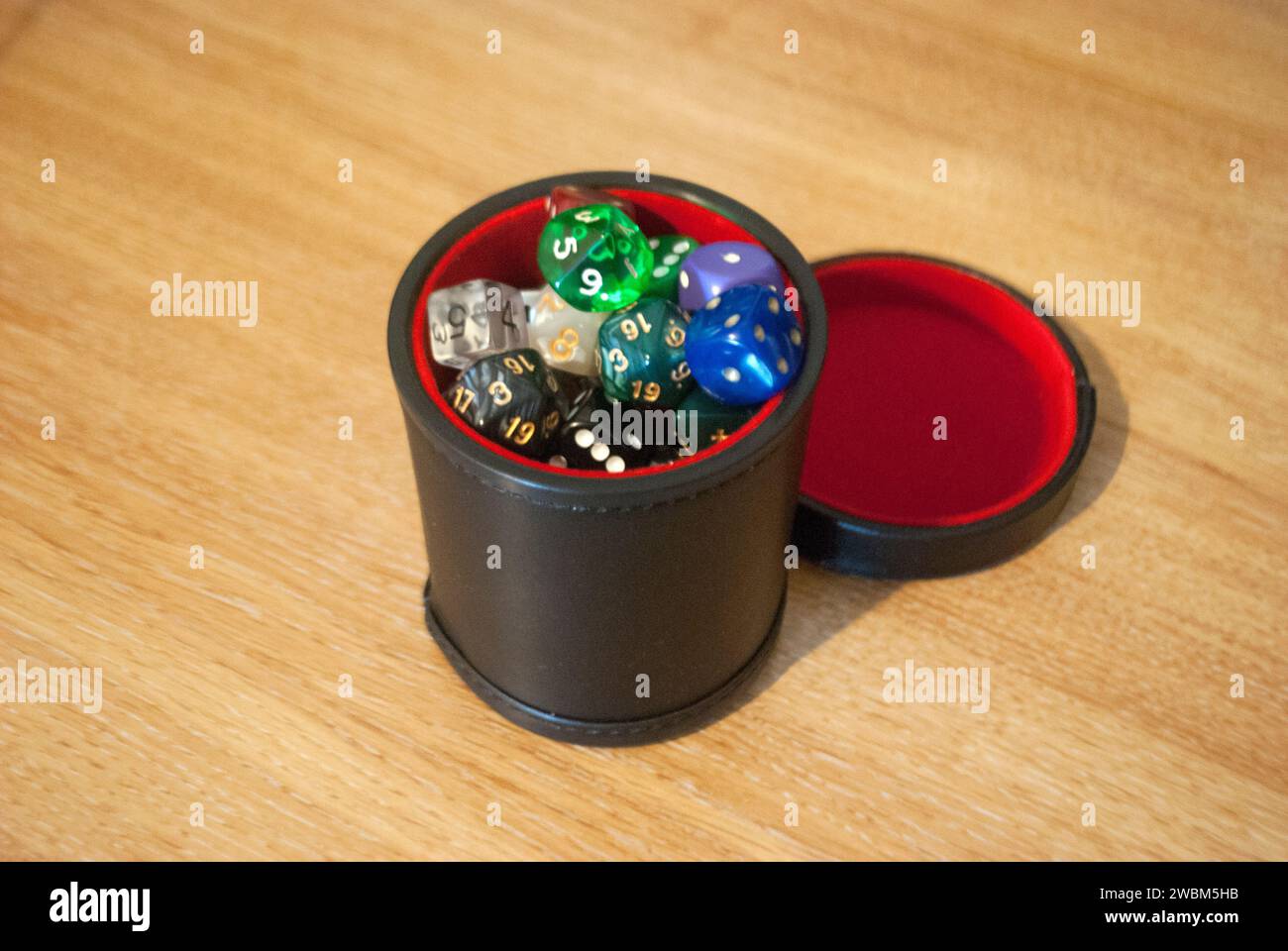 Black dice cup filled with dice Stock Photo