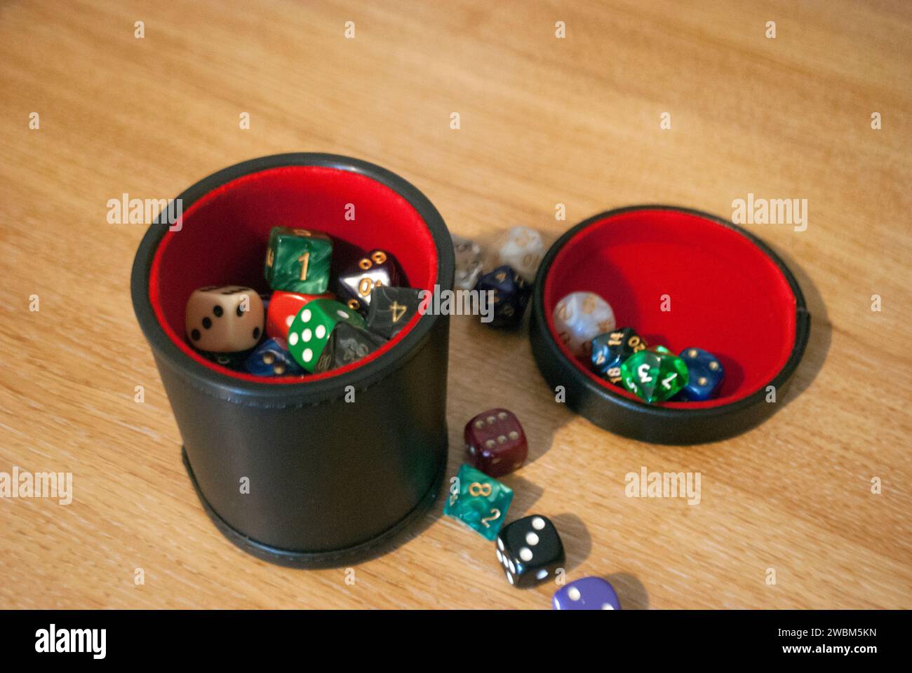 Black dice cup filled with dice Stock Photo