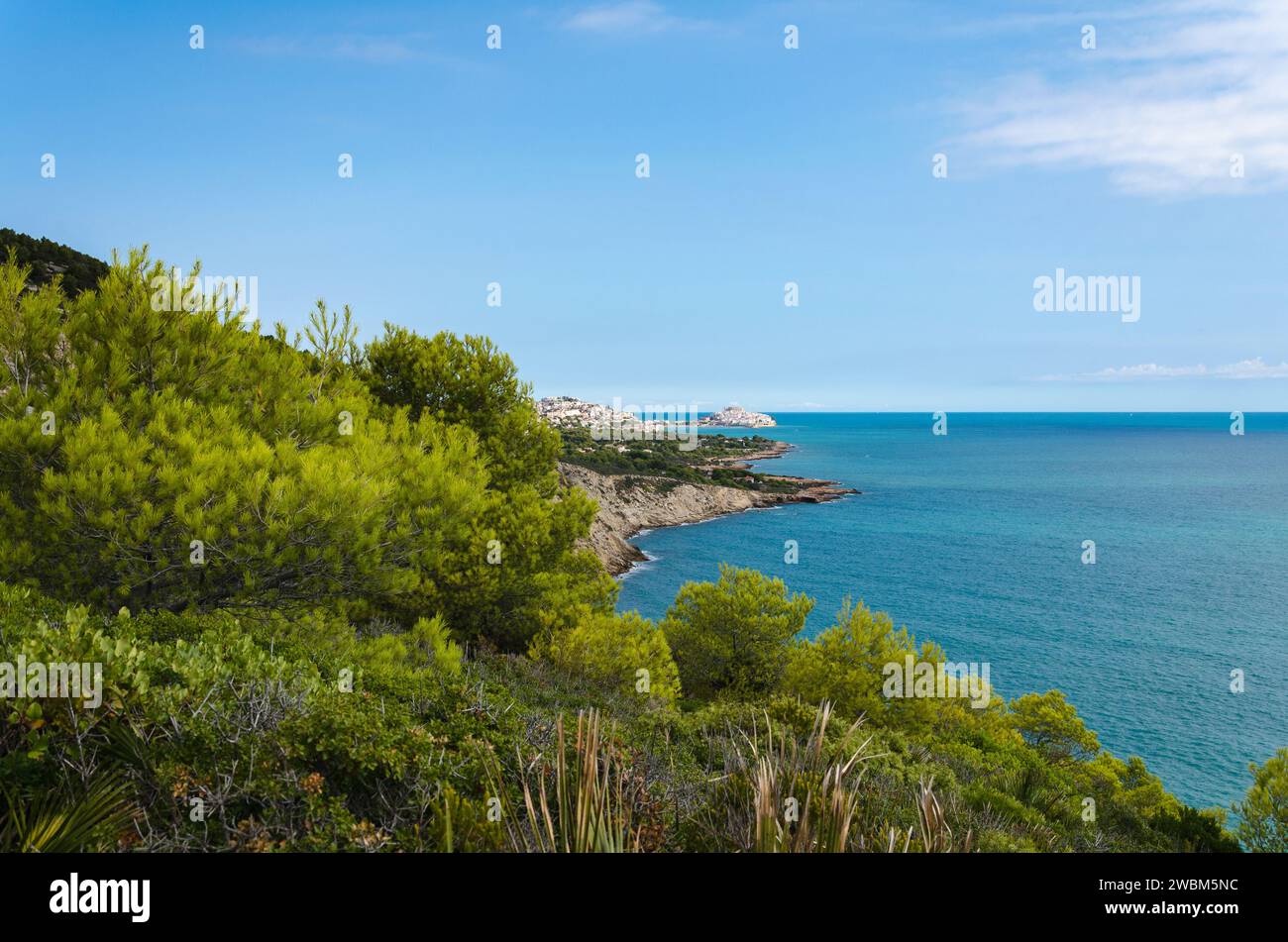 Natural landscape of Sierra de Irta with the medieval village of Peniscola in th background on a day with blue sky, Castellon, Spain Stock Photo