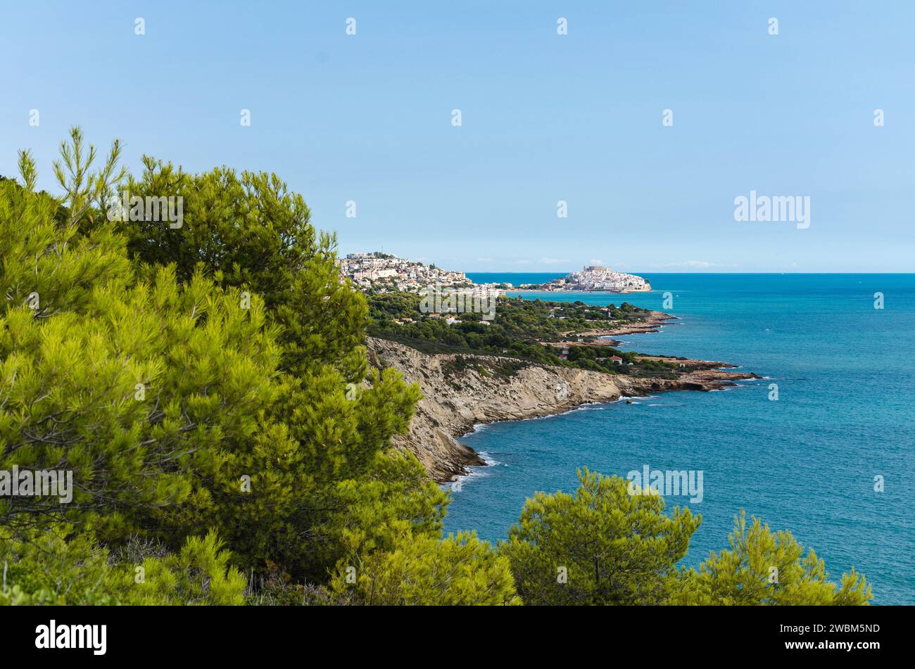 Natural landscape of Sierra de Irta with the medieval village of Peniscola in th background on a day with blue sky, Castellon, Spain Stock Photo