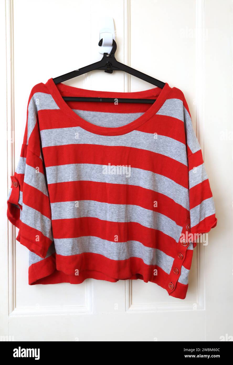 Red and Grey Striped Cropped Sleeve Jumper Stock Photo