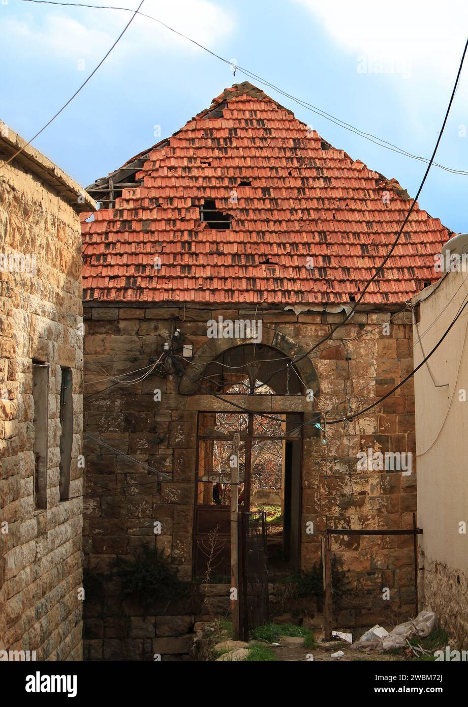 A traditional house in the Lebanese village with a broken roof and door. Stock Photo