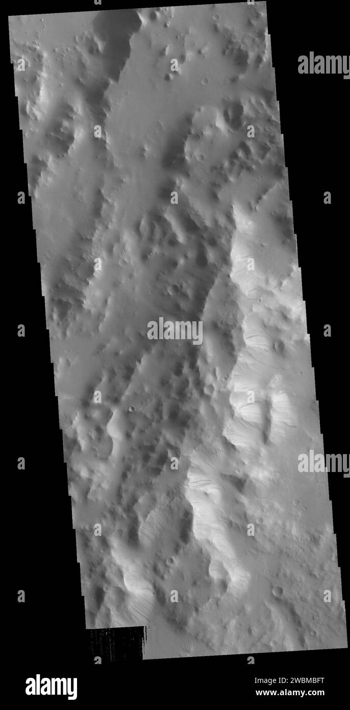 Today's VIS image is located on the eastern margin of Orcus Patera. Dark slope streaks are present on most ridges in the image. Formation of these features is linked to a change in the surface, either removal of the dusty surface revealing darker rock beneath the dust, or a volatile flow along the cliff face. The mechanism that formed Orcus Patera is unknown. While the term patera is tied to volcanic activity, the elongate shape might also have been caused by a low angle meteor impact. Orbit Number 79232 Latitude 12.9315 Longitude 179.284 Instrument VIS Captured 2019-10-25 06 48 Stock Photo