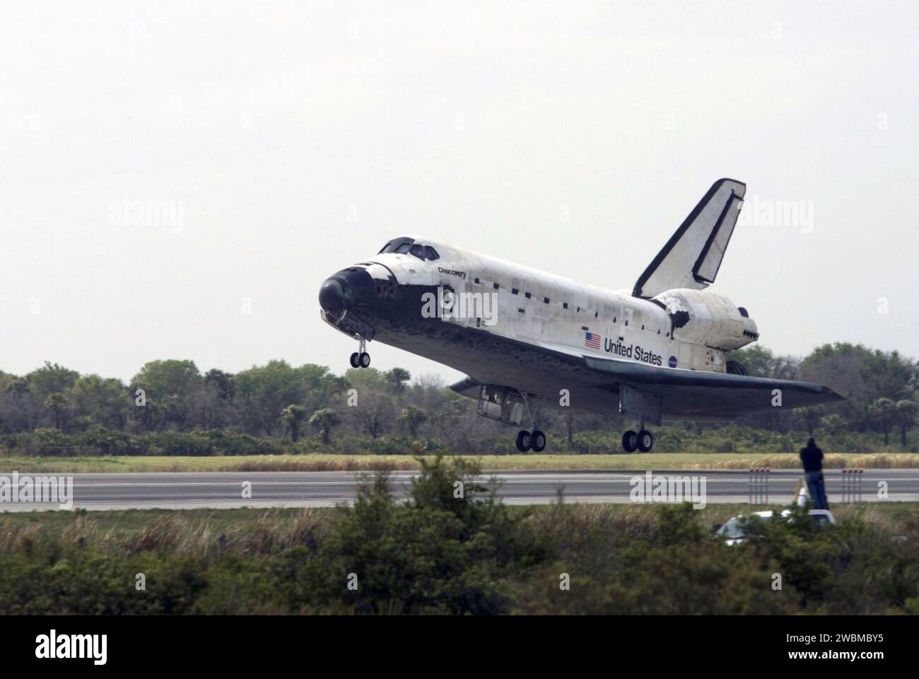 STS119-S-057 (28 March 2009) --- Space Shuttle Discovery approaches landing on Runway 15 of the Shuttle Landing Facility at NASA's Kennedy Space Center, concluding the 13-day, 5.3-million mile journey of the STS-119 mission to the International Space Station. Onboard are NASA astronauts Lee Archambault, commander; Tony Antonelli, pilot; Steve Swanson, Richard Arnold, Joseph Acaba, John Phillips and Sandra Magnus, all mission specialists. The main landing gear touched down at 3:13:17 p.m. (EDT) on March 28, 2009. The nose gear touched down at 3:13:40 p.m. and wheels stop was at 3:14:45 p.m. Dur Stock Photo