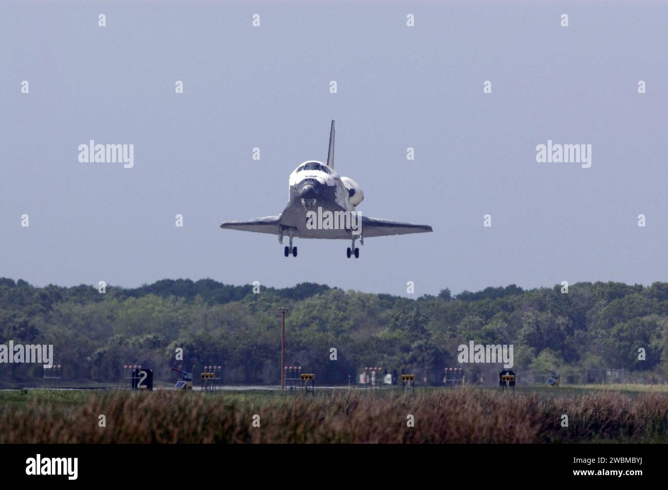 CAPE CANAVERAL, Fla. – Space shuttle Discovery approaches Runway 15 at NASA's Kennedy Space Center in Florida to complete the 13-day, 5.3-million mile journey on the STS-119 mission to the International Space Station. Main gear touchdown was at 3:13:17 p.m. EDT.  Nose gear touchdown was at 3:13:40 p.m. and wheels stop was at 3:14:45 p.m.  Discovery delivered the final pair of large power-generating solar array wings and the S6 truss segment. The mission was the 28th flight to the station, the 36th flight of Discovery and the 125th in the Space Shuttle Program, as well as the 70th landing at Ke Stock Photo