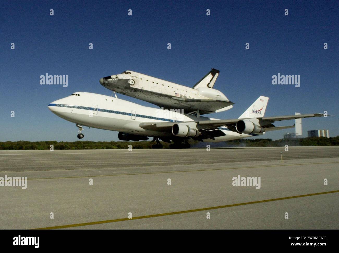 KENNEDY SPACE CENTER, FLA. -- The Shuttle Carrier Aircraft, carrying the orbiter Columbia on its back, touches down on runway 33 at KSC’s Shuttle Landing Facility after a protracted trip from California that began March 1. Unfavorable weather conditions kept it on the ground at Dyess AFB, Texas, until it could return to Florida on March 5 when it landed at the Cape Canaveral Air Force Station Skid Strip. Columbia had to wait for the orbiter Atlantis which had completed a ferry flight to KSC on March 5 to be towed from the SLF before making the final hop to KSC. Columbia is returning from a 17- Stock Photo