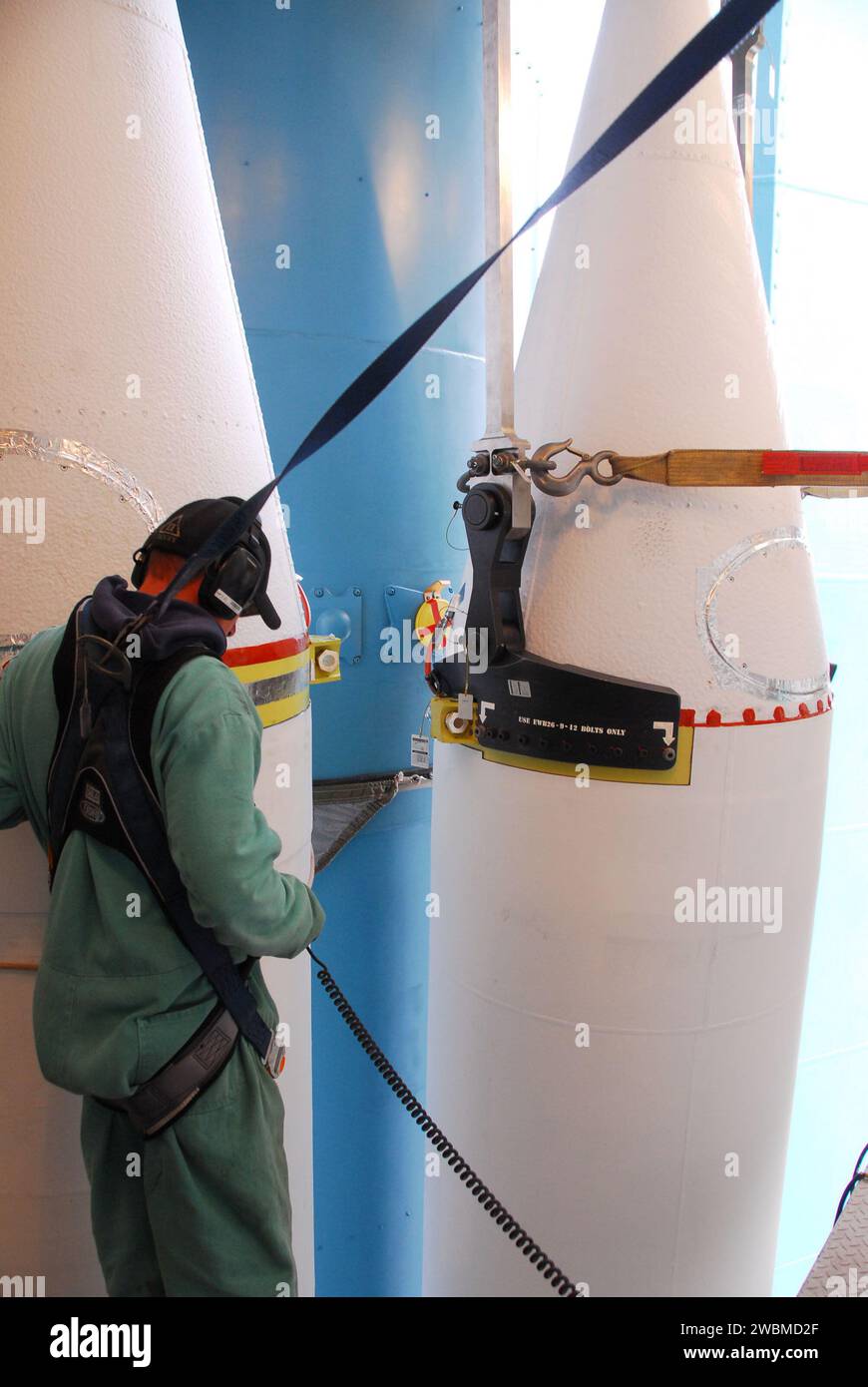 VANDENBERG AIR FORCE BASE, Calif. -- At NASA’s Space Launch Complex-2 at Vandenberg Air Force Base in California, a technician in a safety harness monitors the progress as a solid rocket motor is attached to the United Launch Alliance Delta II rocket. The Delta II will carry NASA's National Polar-orbiting Operational Environmental Satellite System Preparatory Project (NPP) satellite into space. NPP represents a critical first step in building the next-generation of Earth-observing satellites. NPP will carry the first of the new sensors developed for this satellite fleet, now known as the Joint Stock Photo