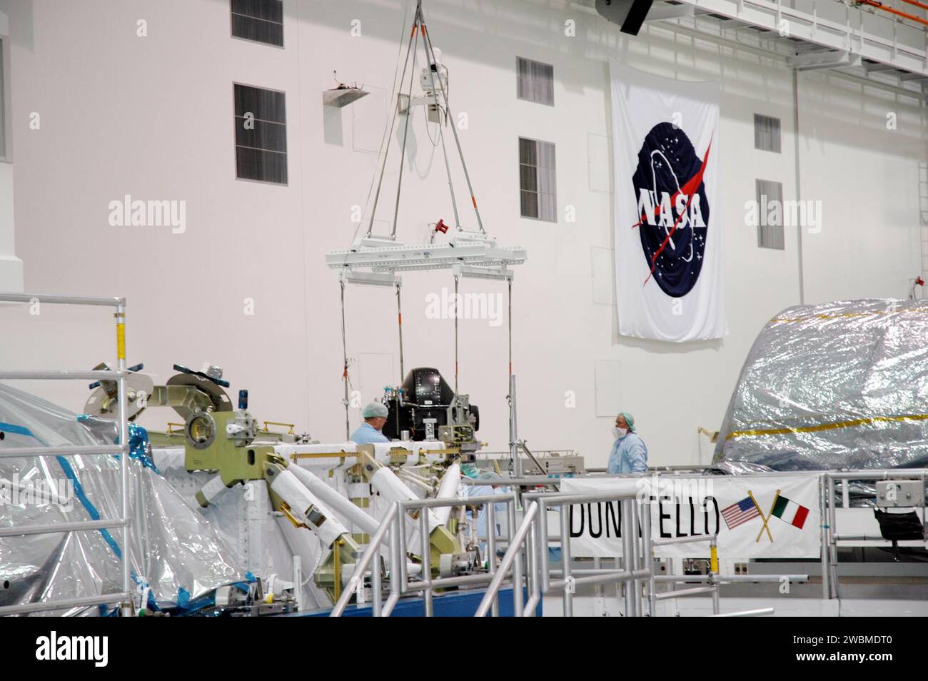 KENNEDY SPACE CENTER, FLA. In the Space Station Processing Facility, technicians attach the