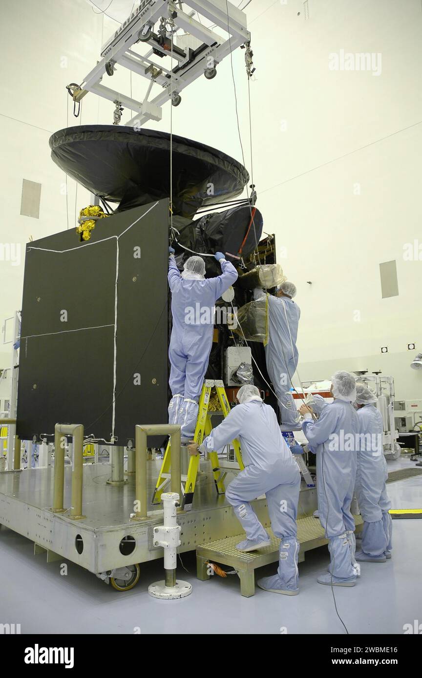 Workers at the Payload Hazardous Servicing Facility attach an overhead ...