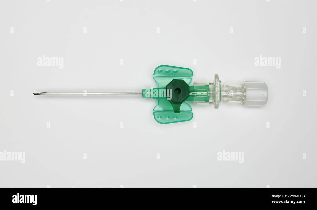 Closeup of one isolated safety IV catheter cannula needle with injection port on white background Stock Photo