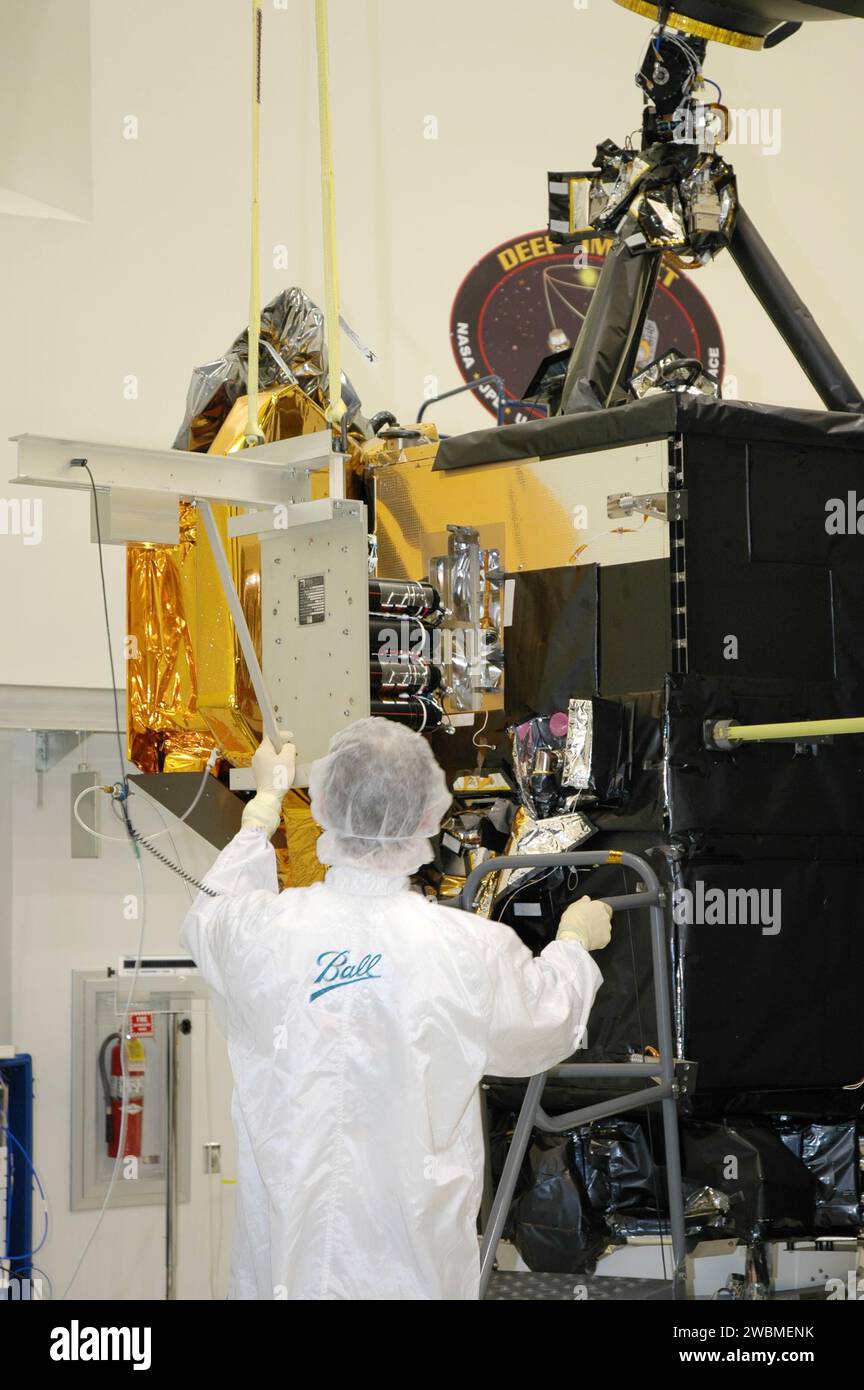 A Ball Aerospace technician at Astrotech Space Operations guides the ...