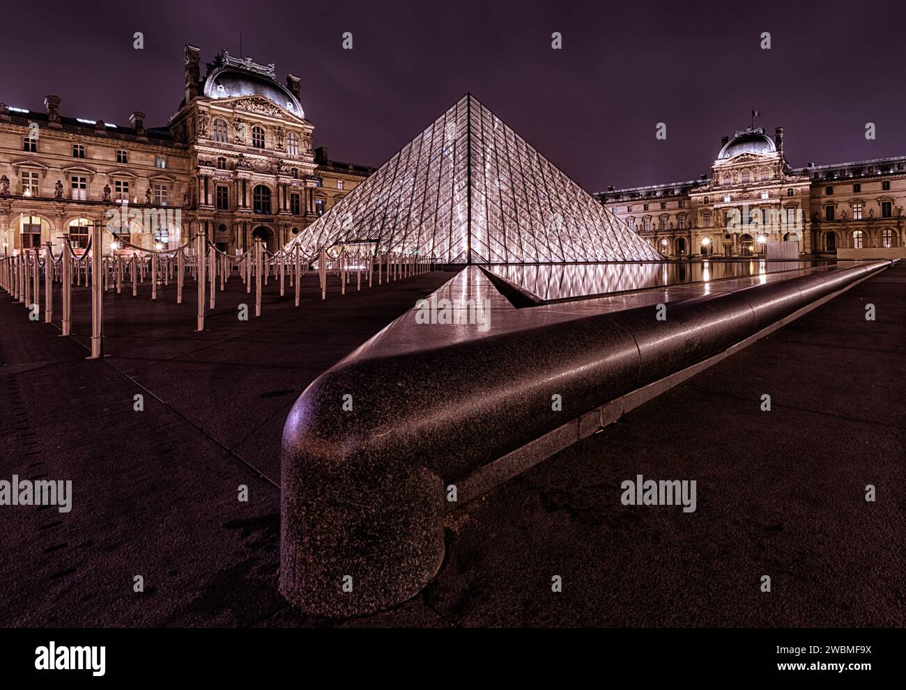 The Louvre, France's National Museum, illuminated at night Stock Photo