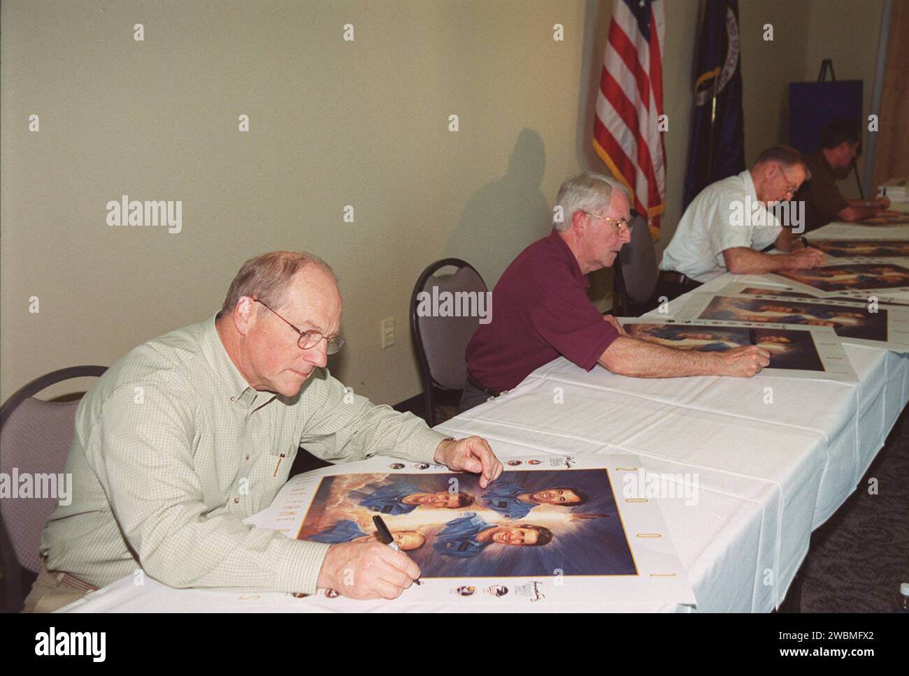 KENNEDY SPACE CENTER, Fla. -- The first four Shuttle astronauts take time to sign posters commemorating their induction into the U.S. Astronaut Hall of Fame Nov. 10. Seated from left are Frederick 'Rick' Hauck, Richard Truly, Joe Engle and Robert Crippen. The event took place at the KSC Visitor Complex Stock Photo