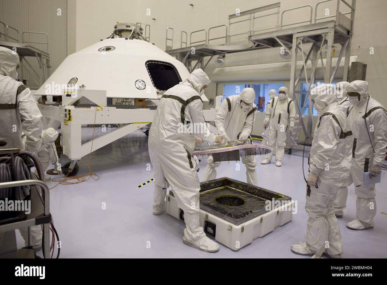 Technicians at Kennedy Space Center prepare the backshell for the Mars ...
