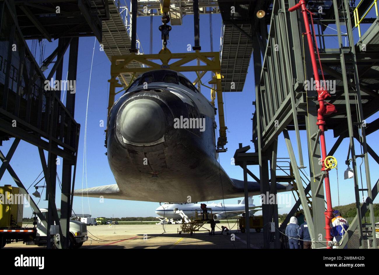 Orbiter Atlantis is suspended by overhead crane in mate-demate device ...