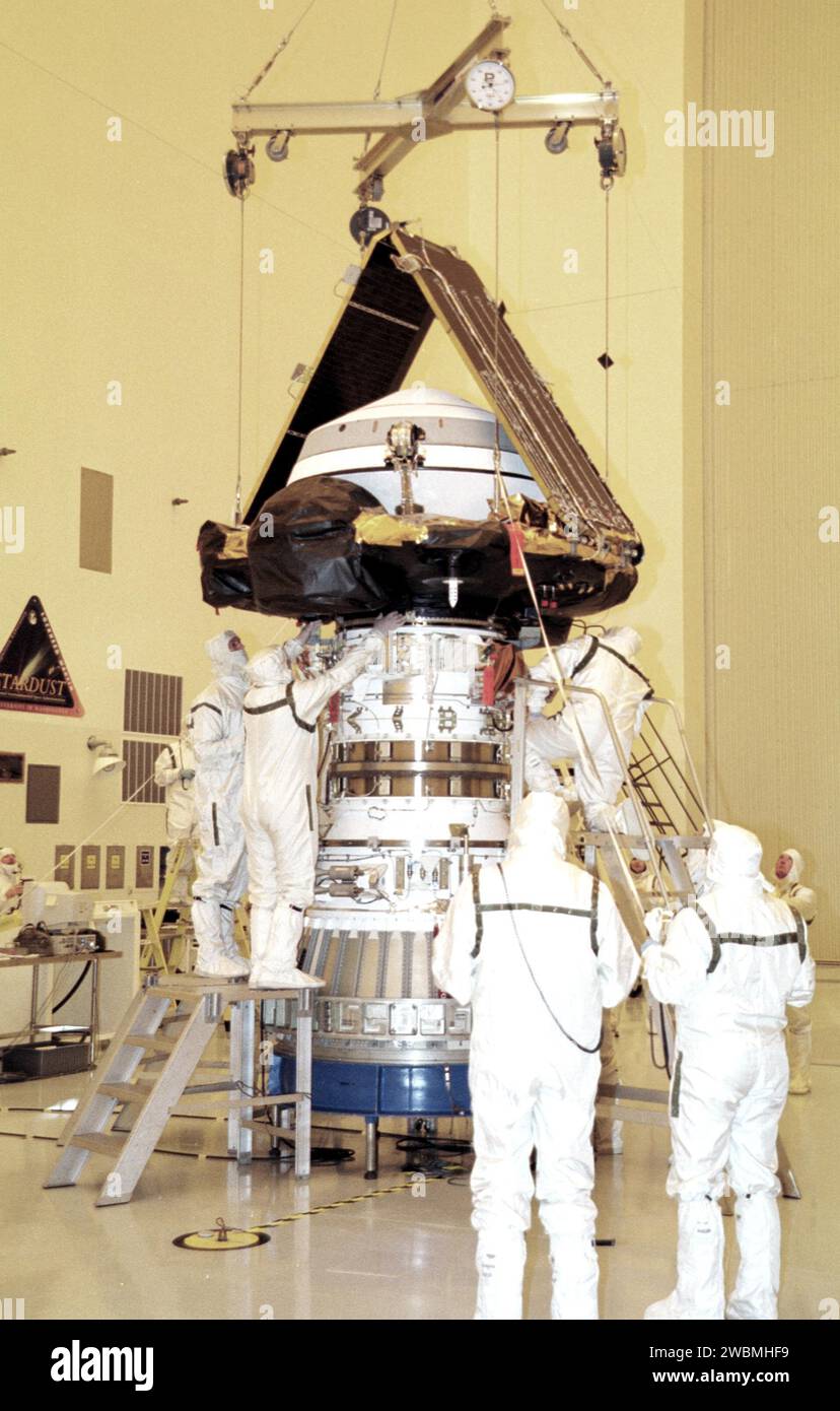 KENNEDY SPACE CENTER, Fla. -- In the Payload Hazardous Servicing Facility, workers check the mating of the Genesis spacecraft with the upper stage of the Delta rocket. Genesis is 7.5 feet (2.3 meters) long and 6.6 feet (2 meters) wide, with a wingspan of solar array 26 feet (7.9 meters) tip to tip. Genesis will be on a robotic NASA space mission to catch a wisp of the raw material of the Sun and return it to Earth with a spectacular mid-air helicopter capture. The sample return capsule is 4.9 feet (1.5 meters) in diameter and 52 inches (1.31 meters) tall. The mission’s goal is to collect and r Stock Photo