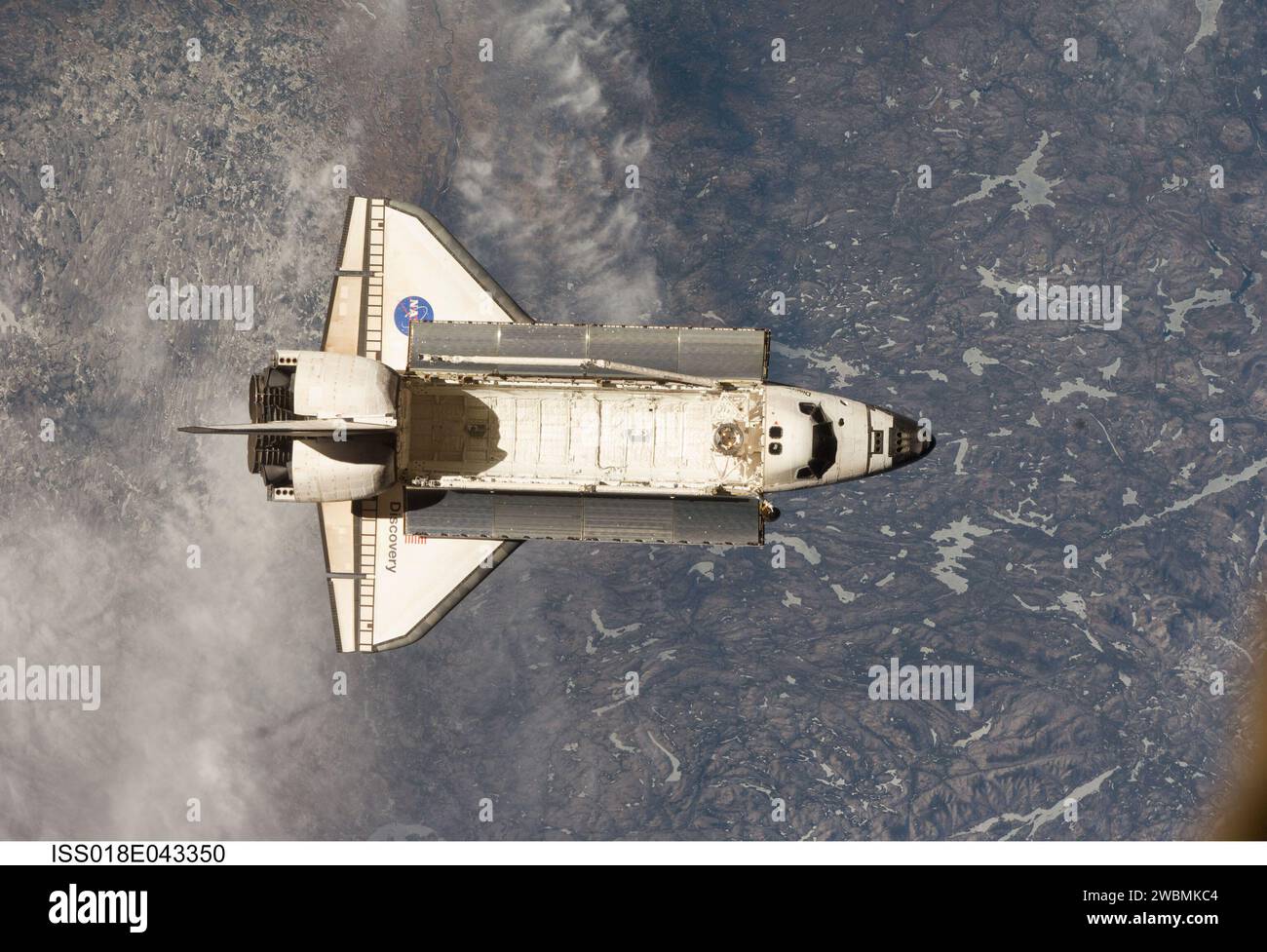 ISS018-E-043350 (25 March 2009) --- Backdropped by a colorful Earth, Space Shuttle Discovery (STS-119) is featured in this image photographed by an Expedition 18 crew member on the International Space Station soon after the shuttle and station began their post-undocking relative separation on March 25, 2009. Stock Photo