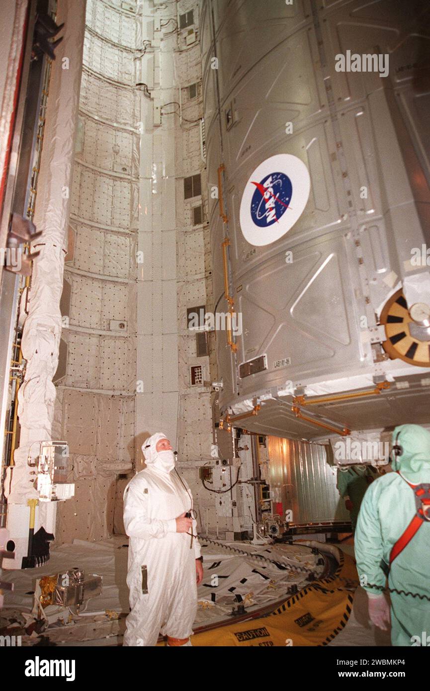 Workers move the U.S. Lab Destiny into the orbiter payload bay via the ...