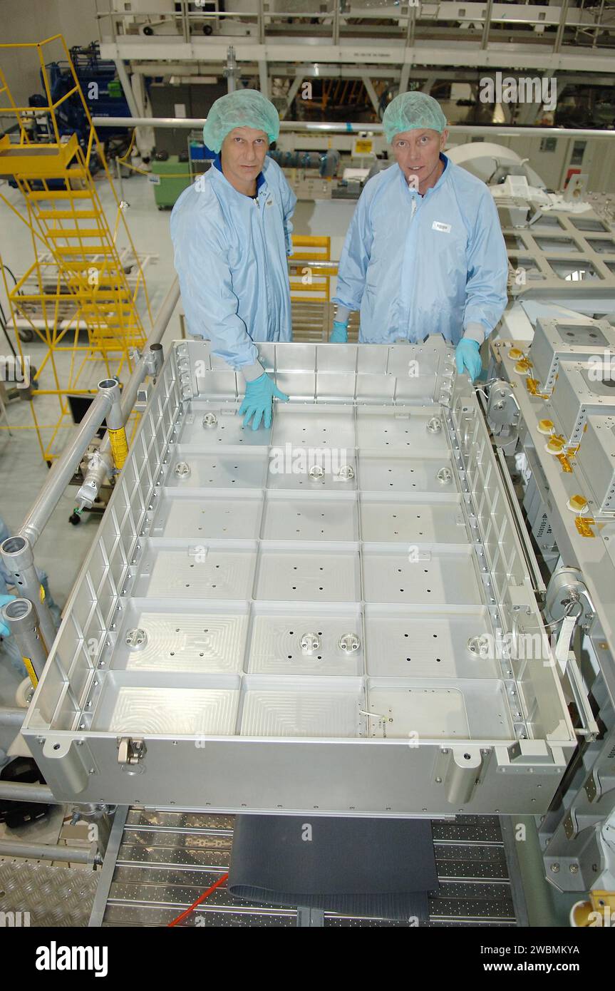 KENNEDY SPACE CENTER, FLA. - In the Space Station Processing Facility at NASA Kennedy Space Center, STS-121 Mission Specialists Piers Sellers (left) and Michael Fossum look at the Detailed Test Objective (DTO) tile sample repair kit situated on the Lightweight Multi-Purpose Experiment Support Structure Carrier (LMC). The STS-121 crew is at KSC to take part in Crew Equipment Interface Test activities, which provide hands-on experience with equipment they will use on-orbit. STS-121, the second Return to Flight mission, is targeted for launch in a lighted planning window of Sept. 9 to Sept. 25. Stock Photo