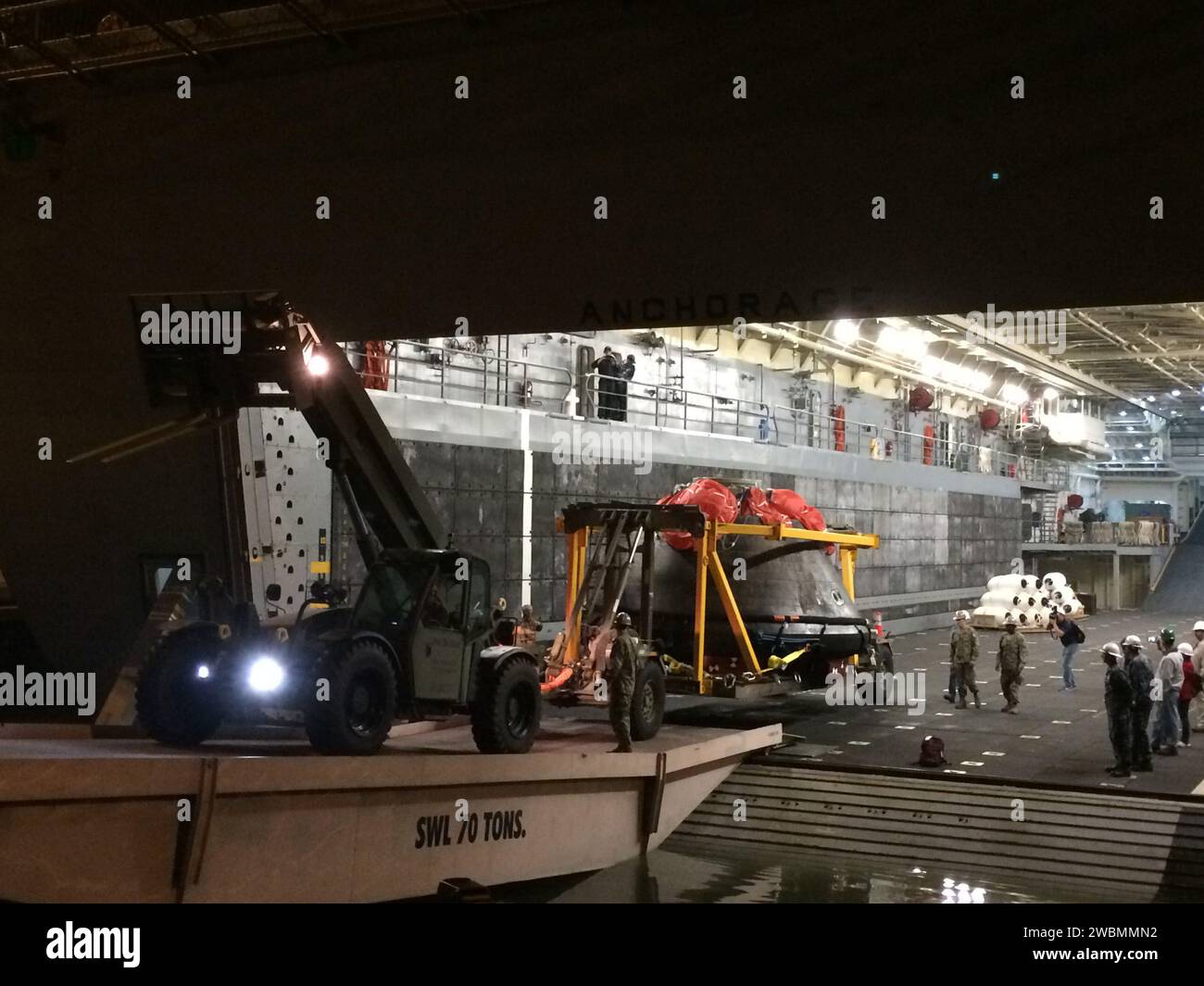 NASA's Orion spacecraft is offloaded from the U.S. Navy's USS Anchorage ...