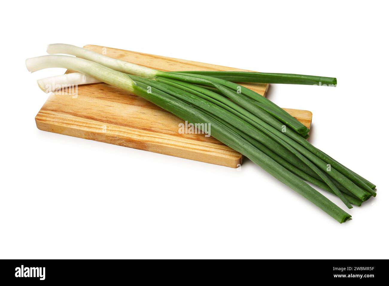 Wooden board with fresh green onion isolated on white background Stock ...