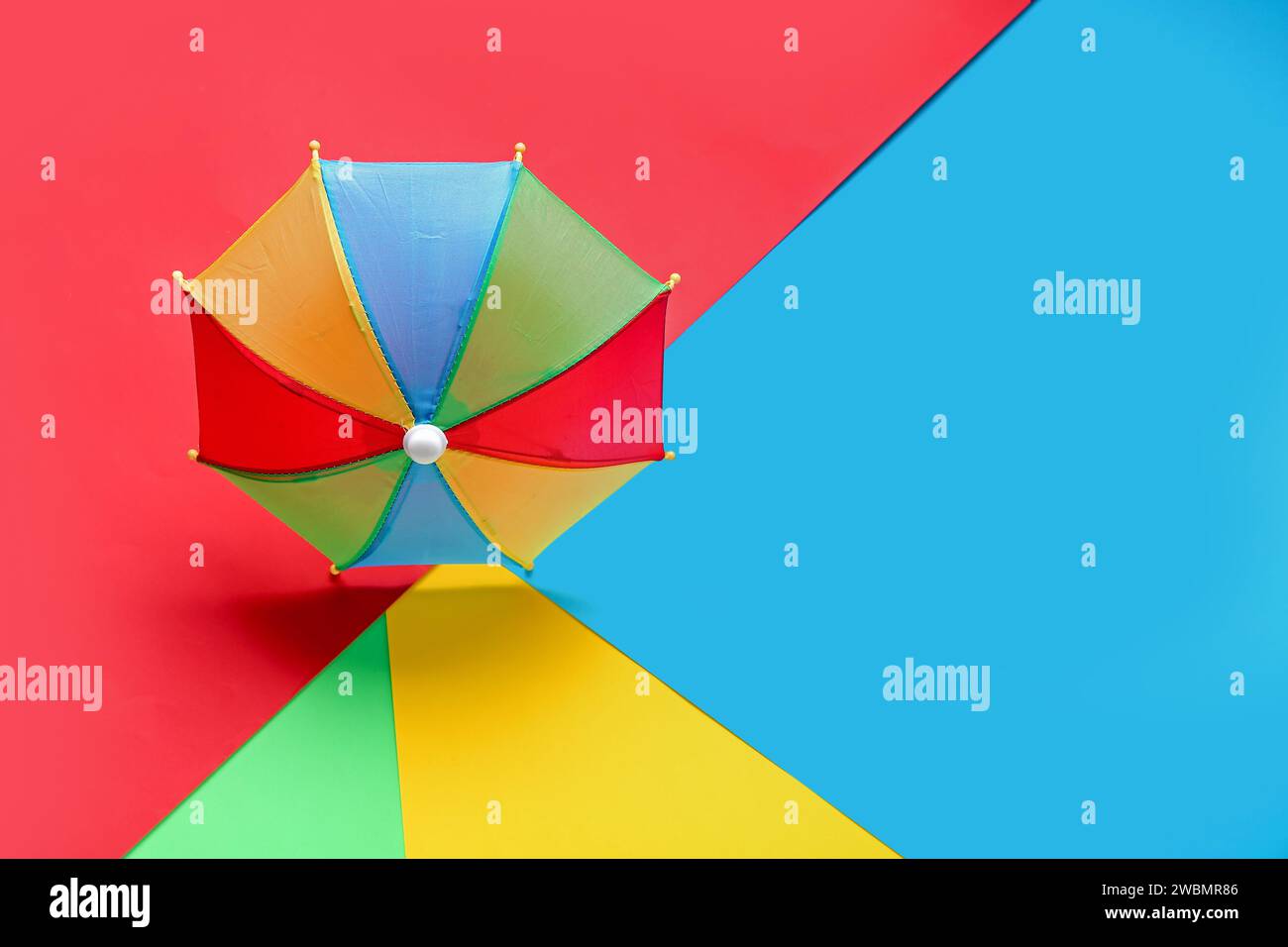 Colorful mini umbrella on color background Stock Photo