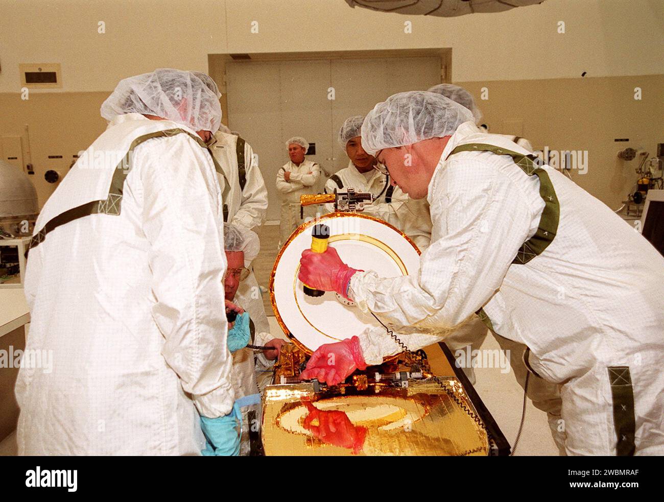 Technicians examine the Gamma Ray Spectrometer (GRS) before it is moved ...