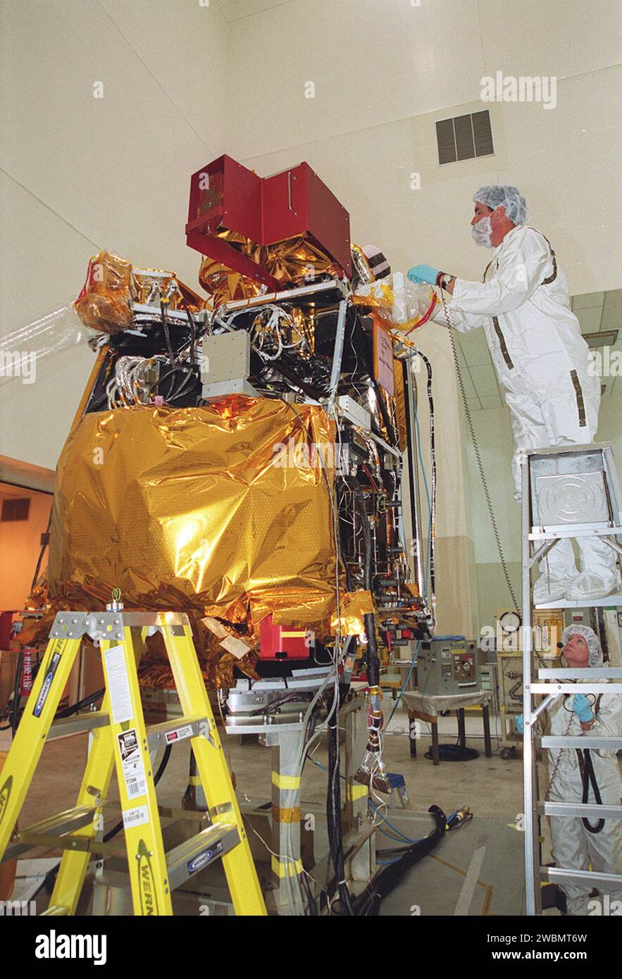 In the Spacecraft Assembly and Encapsulation Facility 2 (SAEF-2), workers prepare to remove the High Energy Neutron Detector (HEND), part of the Gamma Ray Spectrometer (GRS), from the 2001 Mars Odyssey Orbiter. The HEND was built by Russia’s Space Research Institute (IKI). The GRS will achieve global mapping of the elemental composition of the surface and determine the abundance of hydrogen in the shallow subsurface. The orbiter will carry two other science instruments THEMIS and the Mars Radiation Environment Experiment (MARIE). THEMIS will map the mineralogy and morphology of the Martian sur Stock Photo