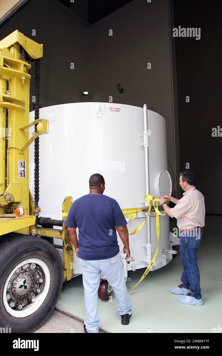 CAPE CANAVERAL, Fla. – A worker releases NASA's Radiation Belt Storm Probe B, enclosed in a protective shipping container, from the forklift that delivered it to the airlock of the Astrotech payload processing facility near NASA’s Kennedy Space Center in Florida where Applied Physics Laboratory technicians will begin spacecraft testing and prelaunch preparations.  The twin RBSP spacecraft arrived at Kennedy’s Shuttle Landing Facility in the cargo bay of a U.S. Air Force C-17 aircraft earlier in the day.     The RBSP mission will help us understand the sun’s influence on Earth and near-Earth sp Stock Photo