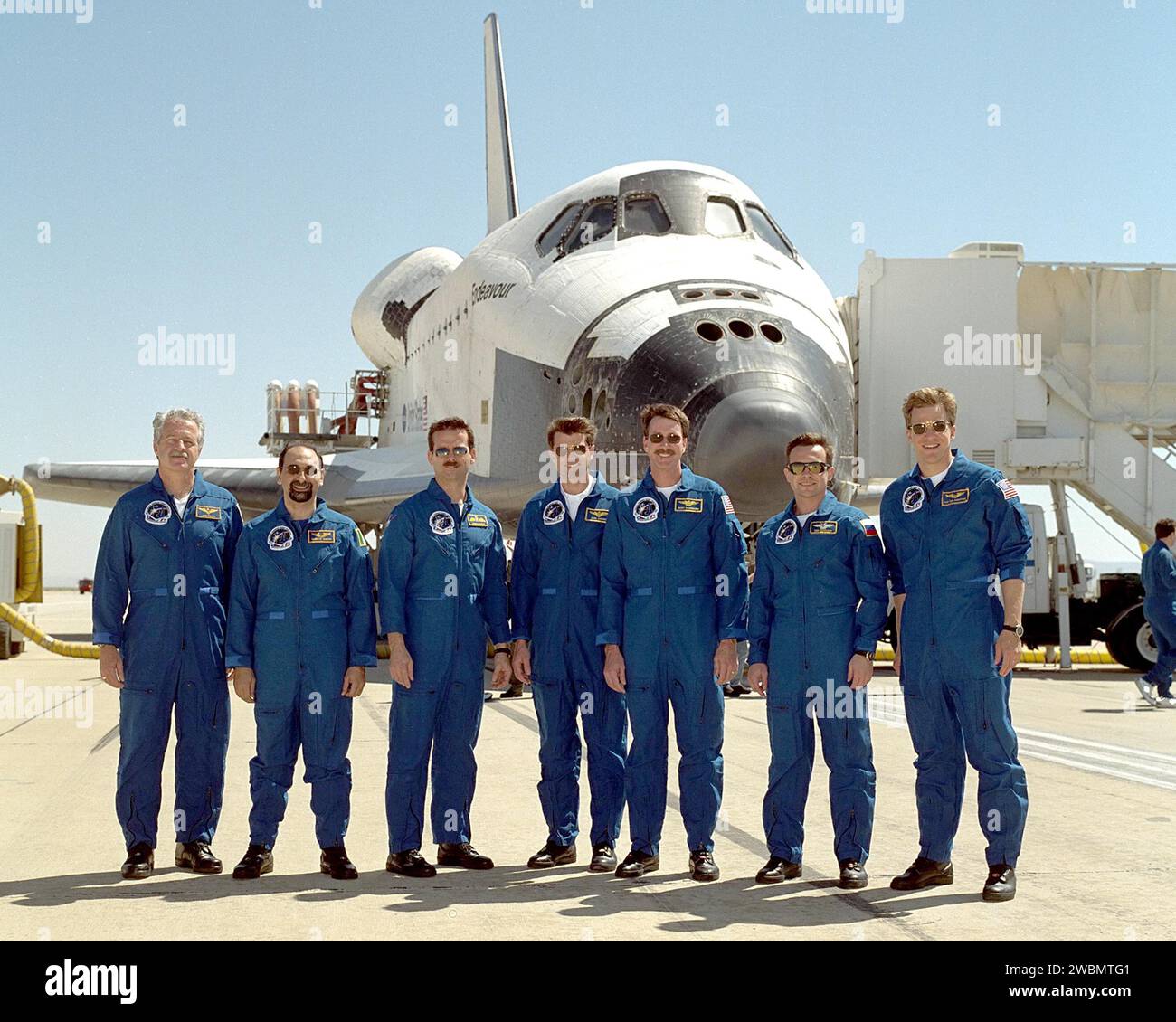The STS-100 crew poses in front of Space Shuttle Endeavour at Edwards ...