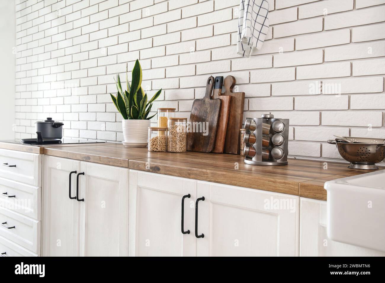Interior of modern kitchen with wooden countertop and utensils Stock ...