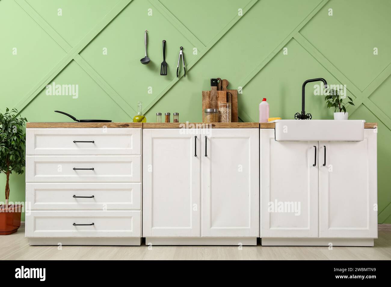 Interior of modern kitchen with white counters, sink and utensils Stock ...