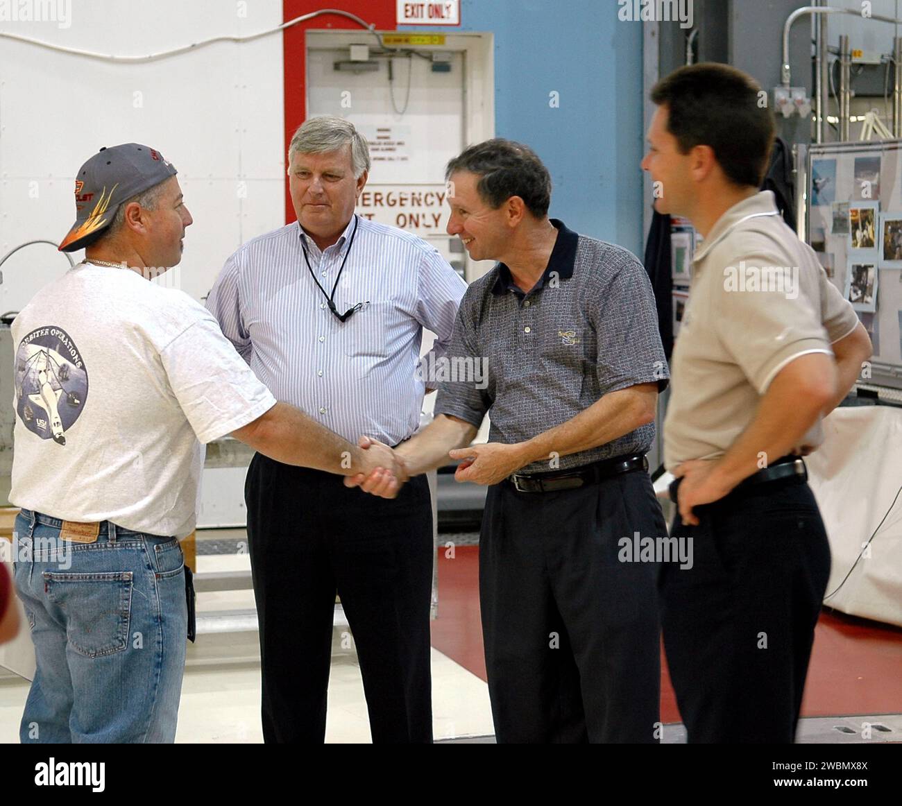 KENNEDY SPACE CENTER, FLA. - Michael Griffin, administrator of the National Aeronautics and Space Administration (NASA), shakes hands with United Space Alliance advanced systems technician Richard Van Wart during a tour of Orbiter Processing Facility bay 1. From left are Van Wart, Center Director James Kennedy, Griffin and Space Shuttle Atlantis vehicle manager Scott Thurston. Space Shuttle Atlantis is being processed for the second Return to Flight mission, STS-121, in the facility. This is Griffin's first official visit to Kennedy Space Center. Griffin is the 11th administrator of NASA, a ro Stock Photo